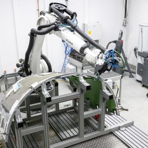 Collaborative industrial robot working on composite aerospace structure in high-precision manufacturing environment