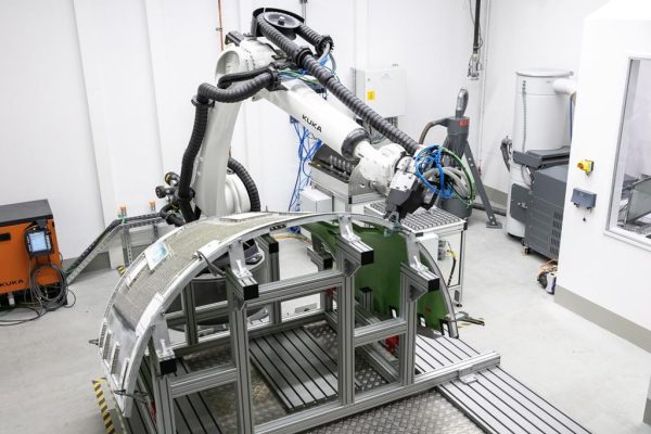 Collaborative industrial robot working on composite aerospace structure in high-precision manufacturing environment